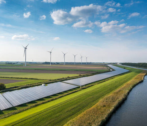 Solar panels and wind turbines generating renewable energy for green and sustainable future.